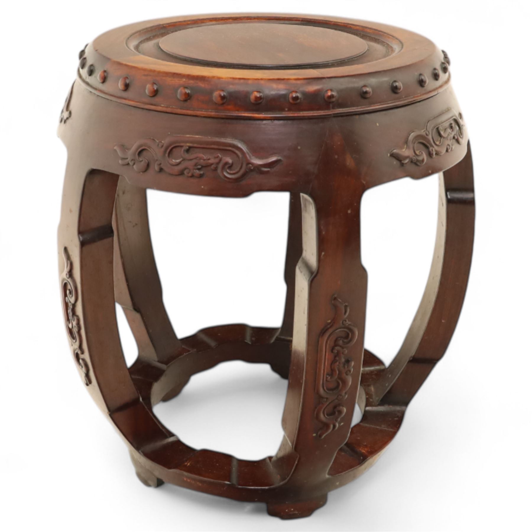 Pair of early 20th century Oriental hardwood barrel seats, of drum form with shaped apron and pierced panels, carved with stylised scrollwork and studded detail to the top