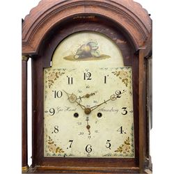 A provincial oak longcase clock retailed by “Geo Hunt, Amesbury” c1820, with a crested break arch pediment and corresponding glazed hood door flanked by two plain pillars with capitals, long trunk with a full length break arch door on a rectangular plinth with a shaped base, painted dial with Arabic numerals, minute markers, subsidiary date and seconds dials and stamped brass hands, matching painted spandrels and a depiction of sea shells to the arch, dial pinned to the movement via a Walker Hughes cast falseplate, with an eight day rack striking movement, striking the hours on a cast bell. With weights and Pendulum




