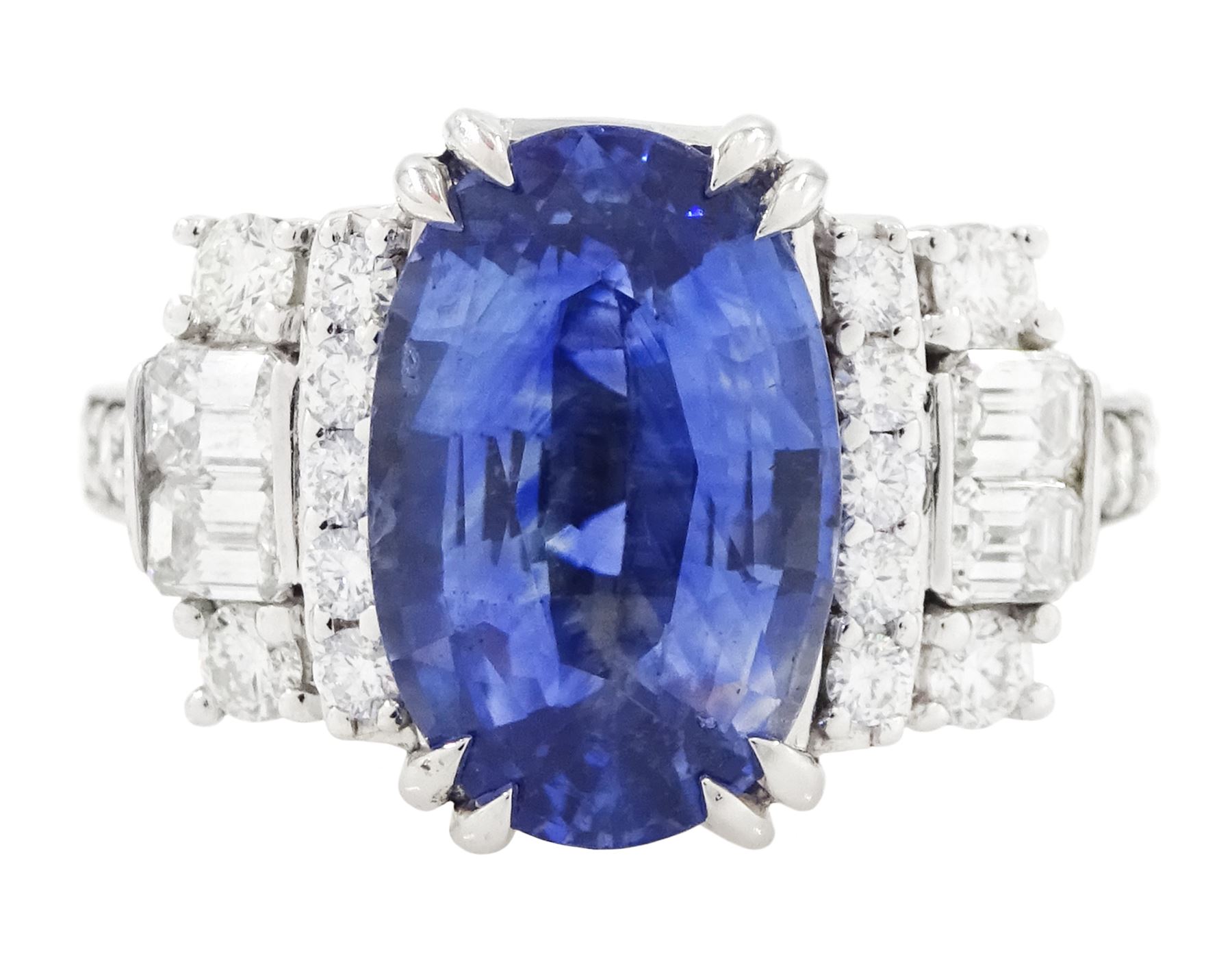 18ct white gold Ceylon sapphire and diamond dress ring, single oval cut sapphire of 4.65 carat, either side set with round brilliant cut and baguette cut diamonds and diamond set shoulders, stamped 750, total diamond weight 0.77 carat, with World Gemological Institute report