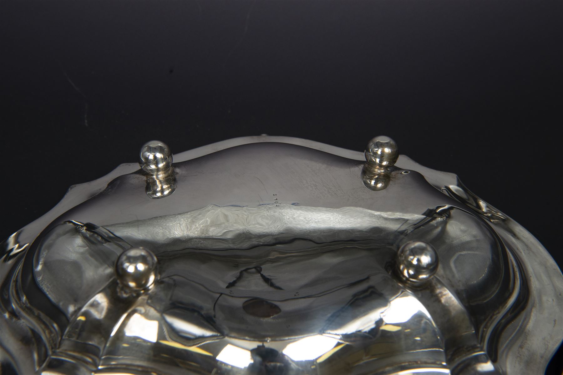 Early 20th century silver swing handled basket, of oval form with shaped rim and upon four bun feet, hallmarked C W Fletcher & Son Ltd, London 1918