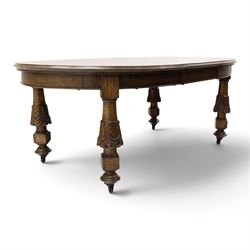 Late 19th century French oak extending dining table, oval top with moulded edge and plain frieze, raised on four ornate carved supports decorate with carved latticework and large festoons with tassels, on turned feet, with two additional leaves
