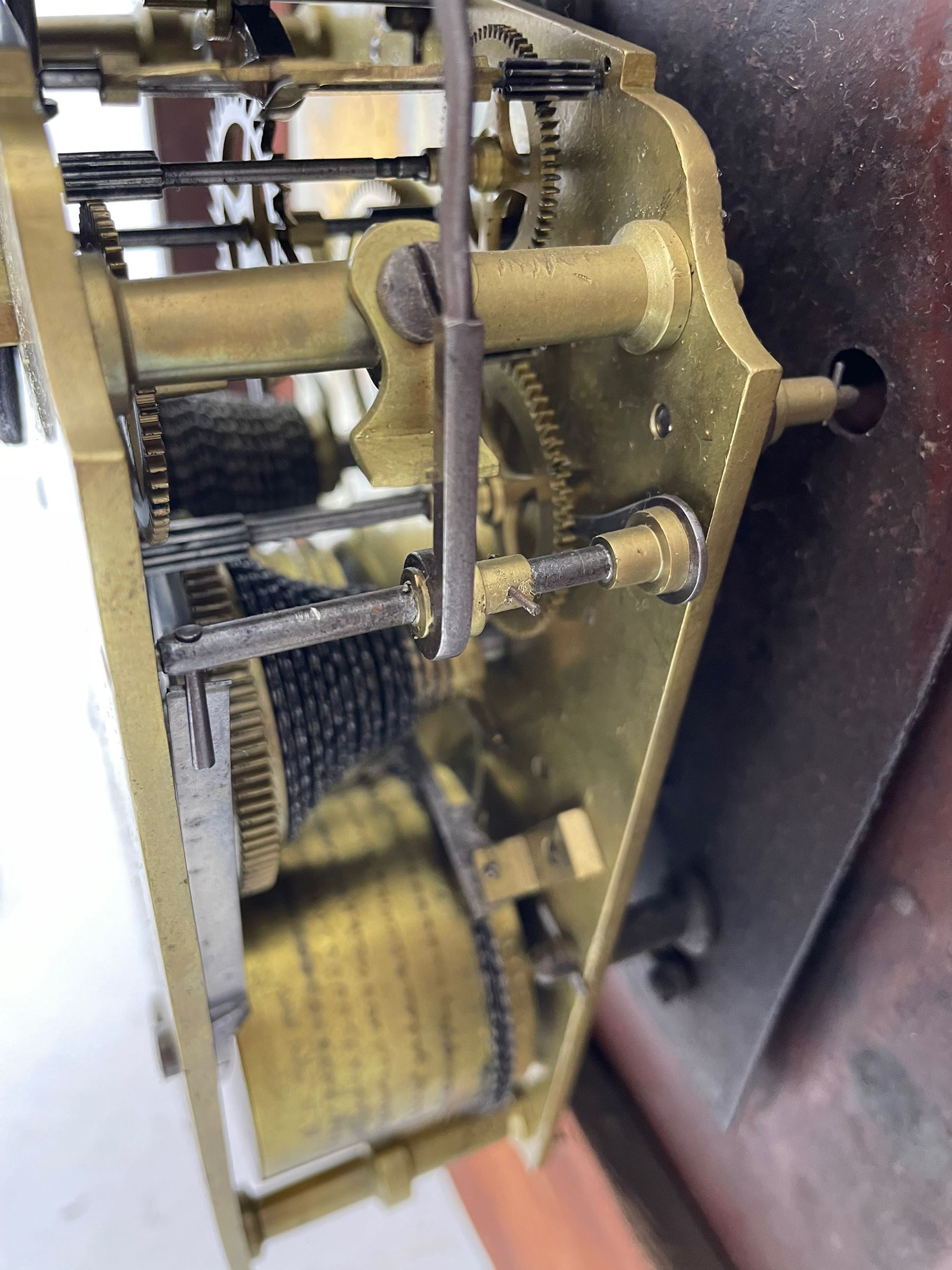 Joseph Critchley of Liverpool -  early 19th century twin fusee 8-day rosewood and mother of pearl inlaid drop-dial wall clock c1820, inlaid circular wooden dial surround with carved ears representing grapes and vine leaves, glazed box with a scroll carved surround, curved base and pendulum adjustment door, 14” painted dial with Roman numerals, minute track, and pierced steel hands within a cast brass bezel and flat glass, dial pinned to a four pillar chain driven fusee movement striking the hours on a bell. With pendulum and key.