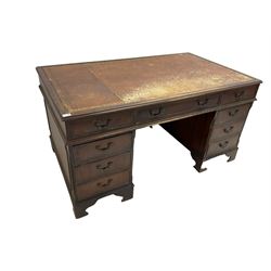 Edwardian mahogany twin pedestal desk, rectangular top with inset leather writing surface, fitted with nine cock-beaded drawers, flanked by reeded canted uprights