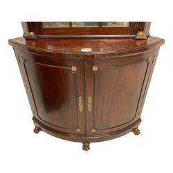 Pair of French Empire design corner cabinets, the straight-front upper section with canted corners and applied half-column pilasters, enclosed by mirror glazed door, the bow-front lower section enclosed by two doors with applied mouldings, mounted by cast metal floral rosettes, skirted base with cast gilt metal hairy paw brass feet