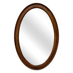 Late 19th century black-painted cane seat chair; early 20th century radial spindle-back chair with green upholstery; early 20th century mahogany single-drawer side table; mid-20th century carved wooden stool with harp motif; early 20th century hexagonal bamboo stand; two oval mirrors (7)