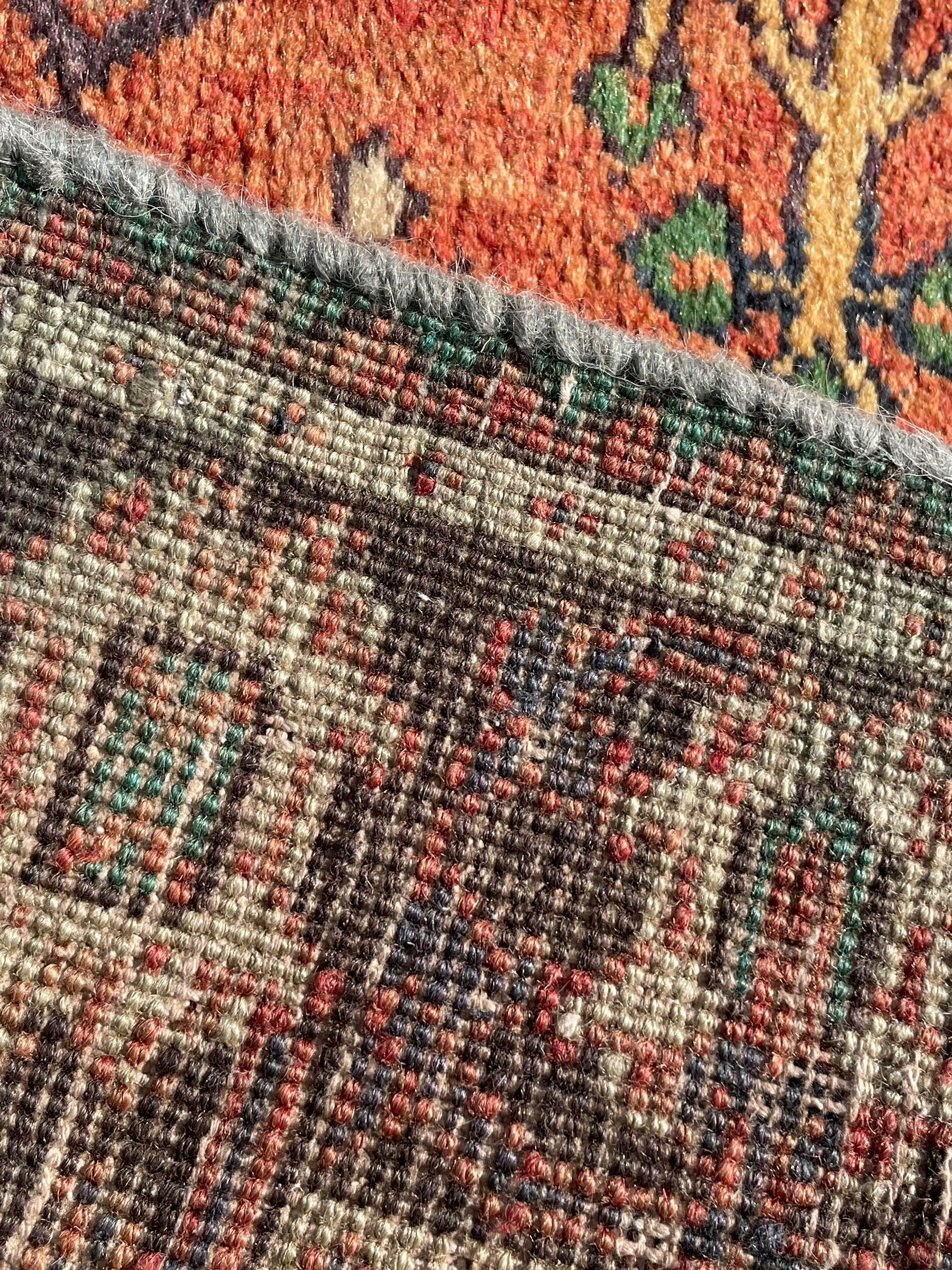 Persian Joshaghan rust ground rug, stepped lozenge medallion surrounded by repeating foliate lozenge motifs, the border decorated with stylised plant motifs, within geometric guard stripes
