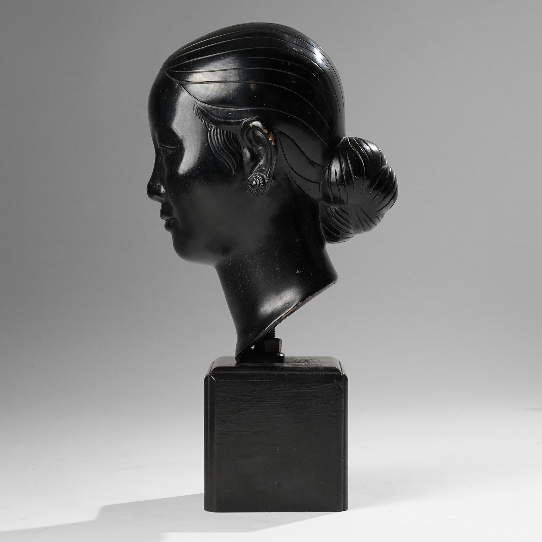 Manner of Nguyen Thanh Le (Vietnamese 1919-2006): Head of a Woman, bronze bust with indistinct character signature to neck, on ebonised base, H27cm 