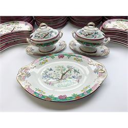 Extensive Victorian Powell and Bishop dinner service, comprising forty two dinner plates, thirty four salad plates, thirty bowls, eighteen bone dishes, pair of sauce tureen and covers with stands, pair of tureen and covers with pierced inserts, footed tureen (without cover), large footed tureen and cover with stand, and seven graduated oval platters, decorated with Oriental style scene of birds amidst blossoming plants and tree, within puce rims, with various marks beneath including impressed Caduceus, printed Caduceus and Bisto mark, printed retail mark 'Manufactured for E Henderson China Rooms Sunderland', and pattern number 