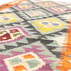 Chobi flatweave kilim runner with a repeating stepped diamond medallion design in live green, rust, teal, purple, and ivory, framed by chevron and geometric borders