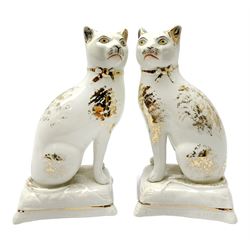Pair of Victorian Staffordshire cats, modelled seated upon cushions, with gilt detail throughout, H18cm