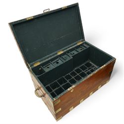 Early 19th century teak and brass bound silver campaign chest, fitted with brass L-shaped brackets and heavy weight carrying handles, the hinged lid enclosing two removeable trays with divisions and lined in blue baize, fitted with two 'R. Cooper & Son' brass locks