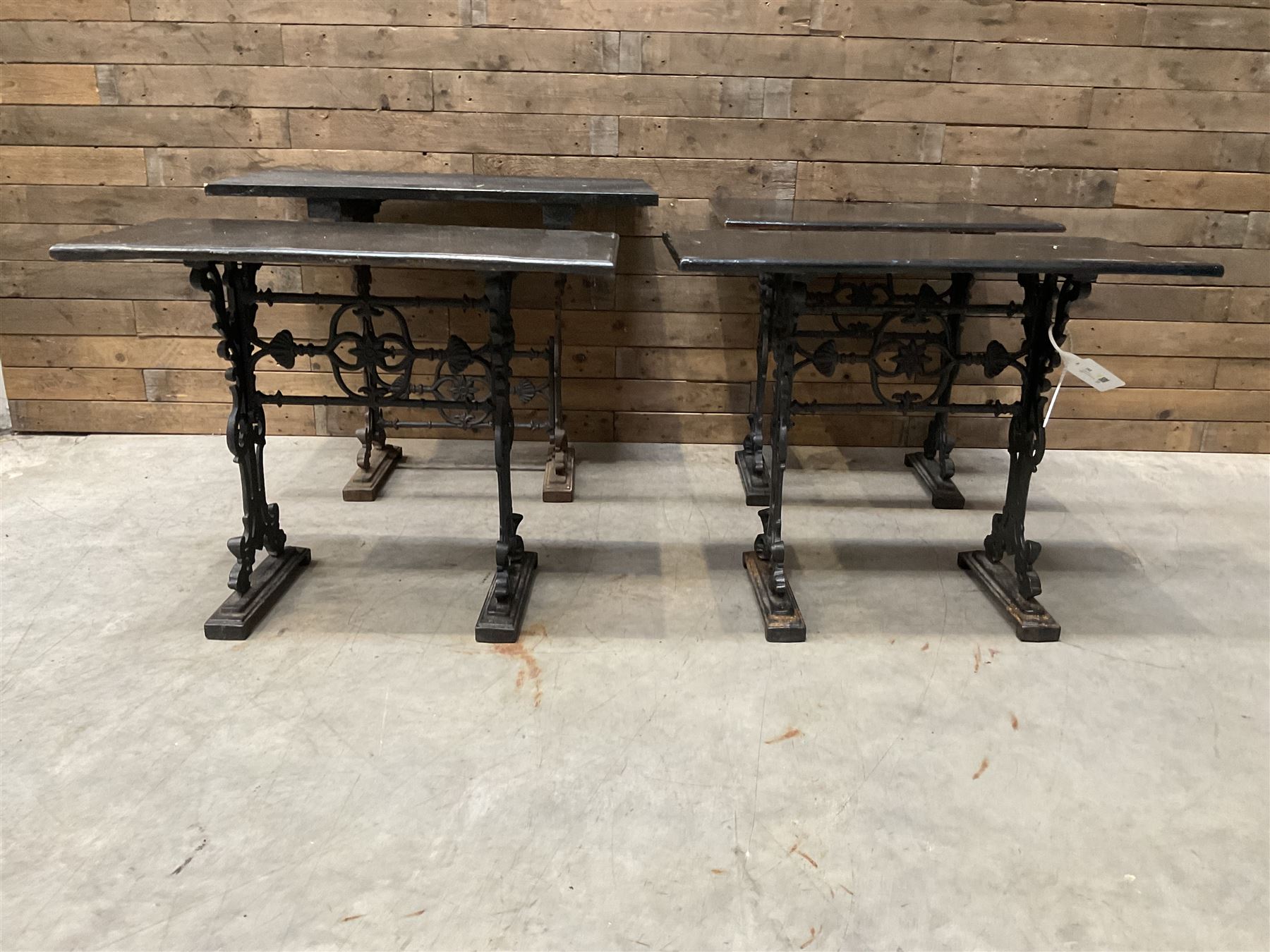 Four cast iron pub or bar tables with rectangular tops