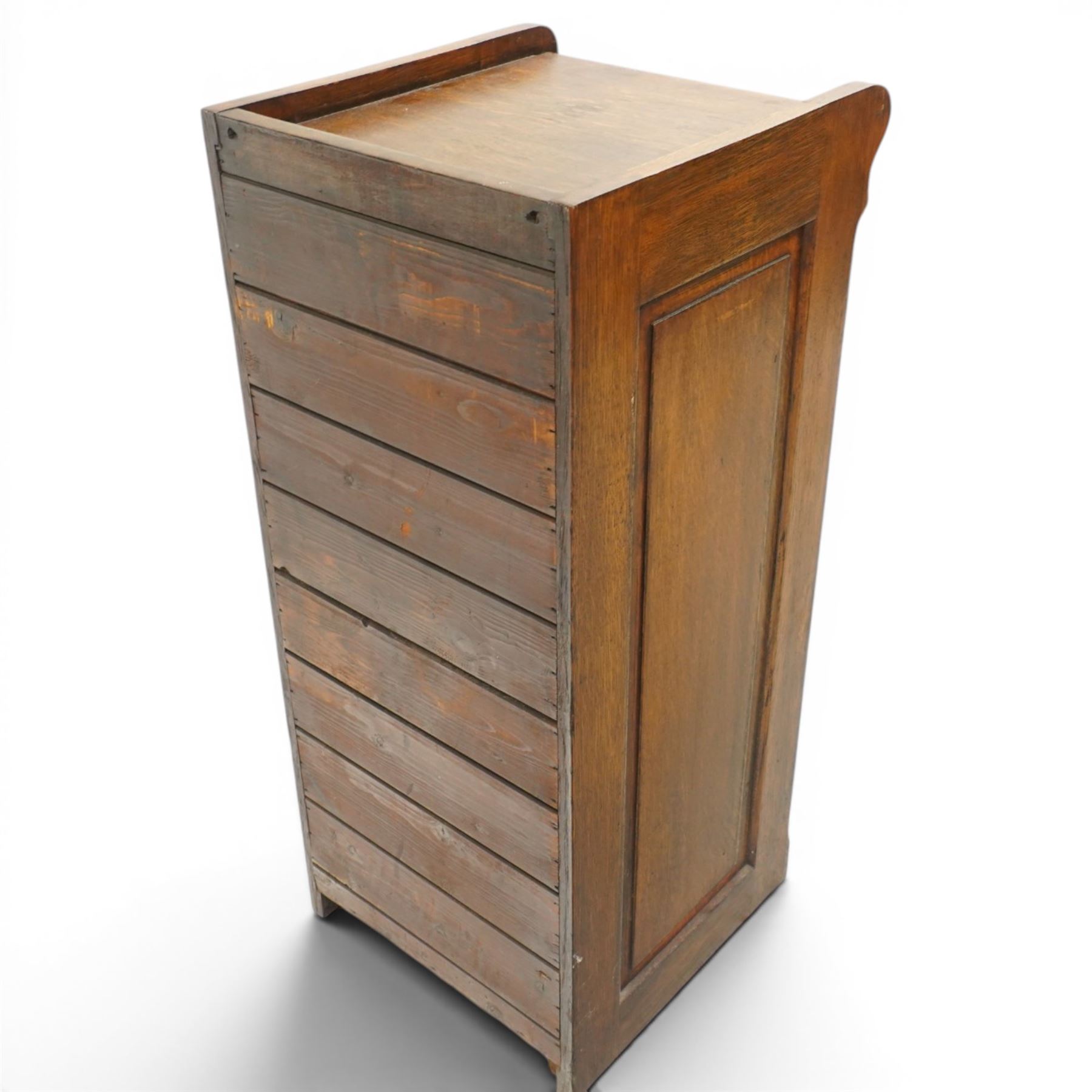 Edwardian oak pedestal filing cabinet, rectangular top with raised three-quarter gallery top, fitted with six drawers with interior paper-stays and brass handles, on plinth base