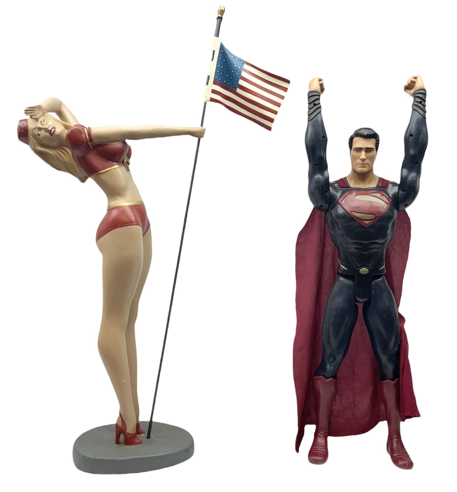 Composite Superman with cape, together with a composite female statue holding the American flag, tallest example H103cm