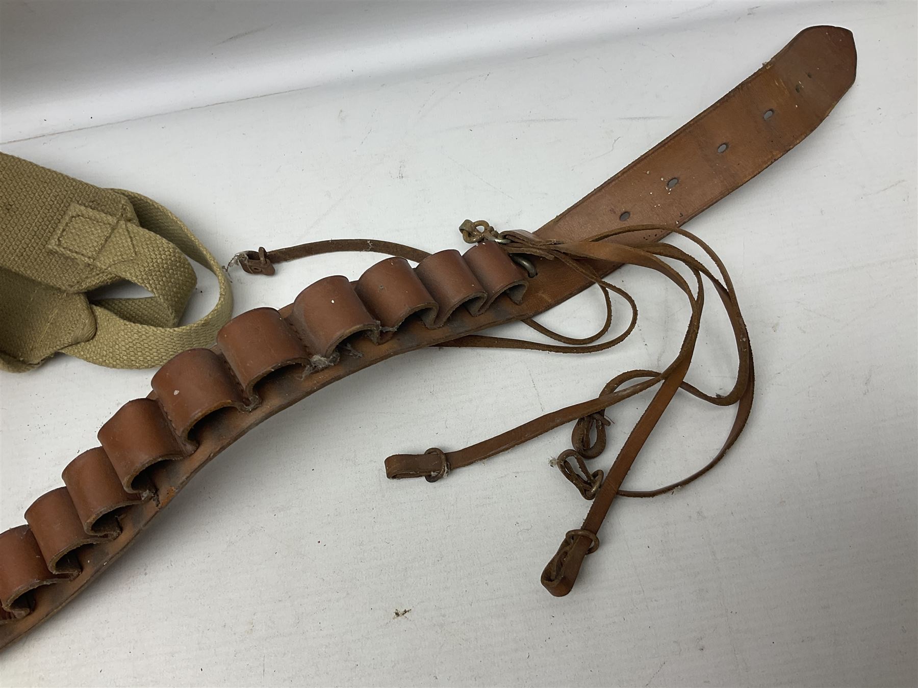 Mundial Brazil bowie knife, the 15.5cm steel blade inscribed 'Sheriff Knife', with banded and aluminium hilt; in leather sheath L29cm overall; British Army felt covered metal water bottle with webbing strap; leather 12-bore cartridge belt; and small pair of non-military binoculars in part case (4)