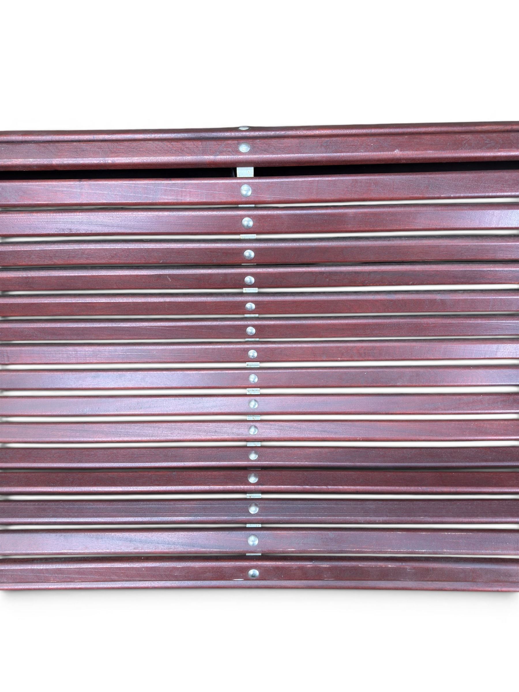 Large late Victorian cast iron garden bench, serpentine form with scroll back and seat, slatted with mahogany stained Sapele