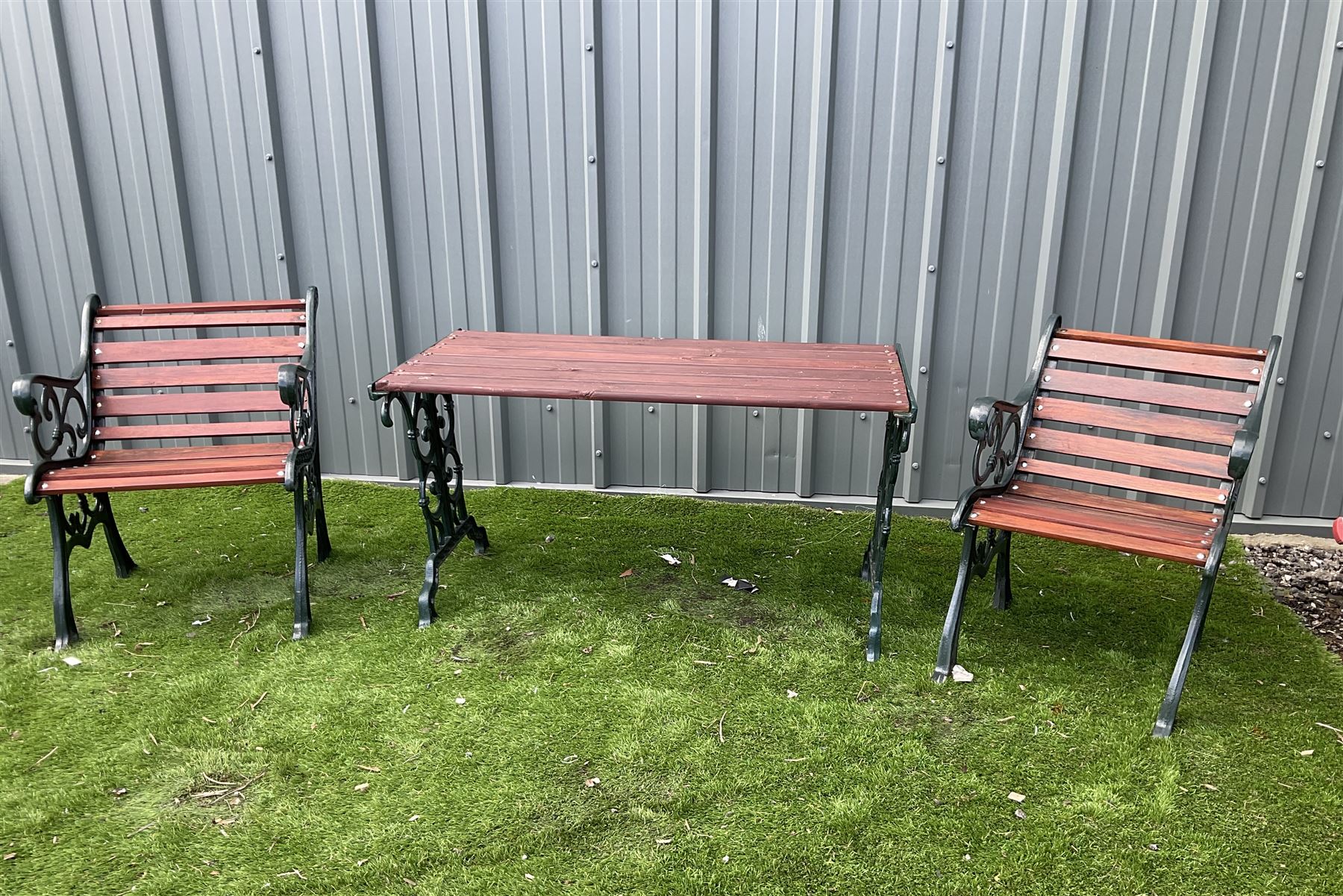 Painted cast iron and wood slated table and two chairs  - THIS LOT IS TO BE COLLECTED BY APPOINTMENT FROM DUGGLEBY STORAGE, GREAT HILL, EASTFIELD, SCARBOROUGH, YO11 3TX