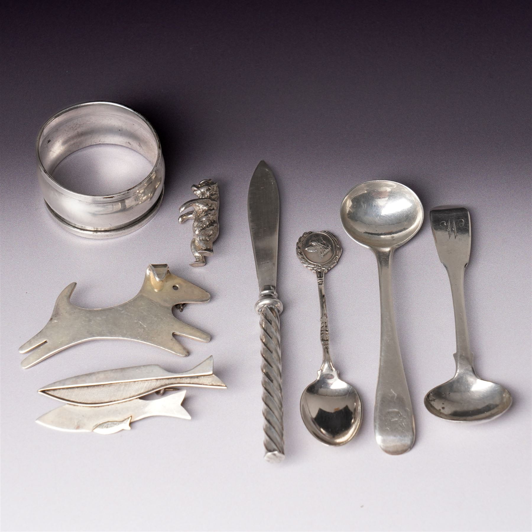 Assorted silver including two 19th century condiment spoons, coffee spoon, napkin ring, knife, two silver brooches and a charm 