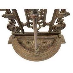 19th century cast iron hallway hat and coat stand, the arched frame decorated with overlapping foliage, central oval mirror surrounded by trailing oak leaves and acorns, with extending umbrella and stick stand, the curved plinth base decorated with acanthus leaves, with impressed and mounted R.d. lozenges