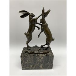 Bronze figure group, modelled as two male hares boxing, upon a naturalistic base signed 'Nick' and with foundry mark, raised upon a rectangular base, overall H24cm