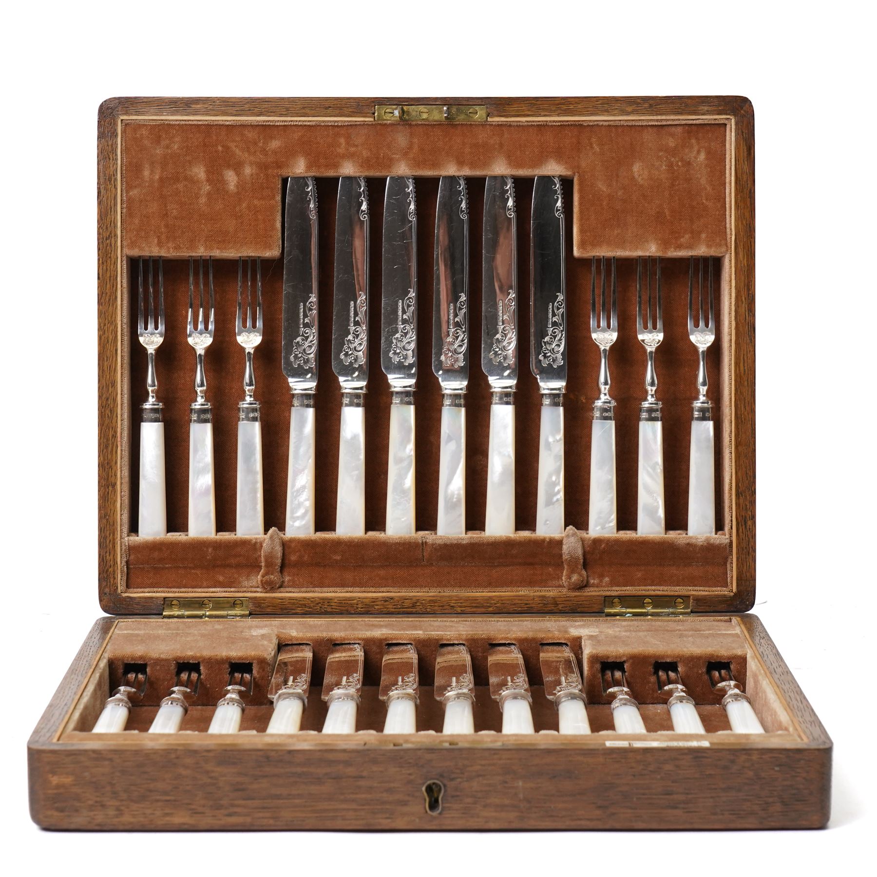 Set of twelve dessert knives and forks with engraved plated blades, silver collars and mother of pearl handles by Walker & Hall in oak box Sheffield 1927 and a set of twelve plated fish knives and forks with servers, boxed