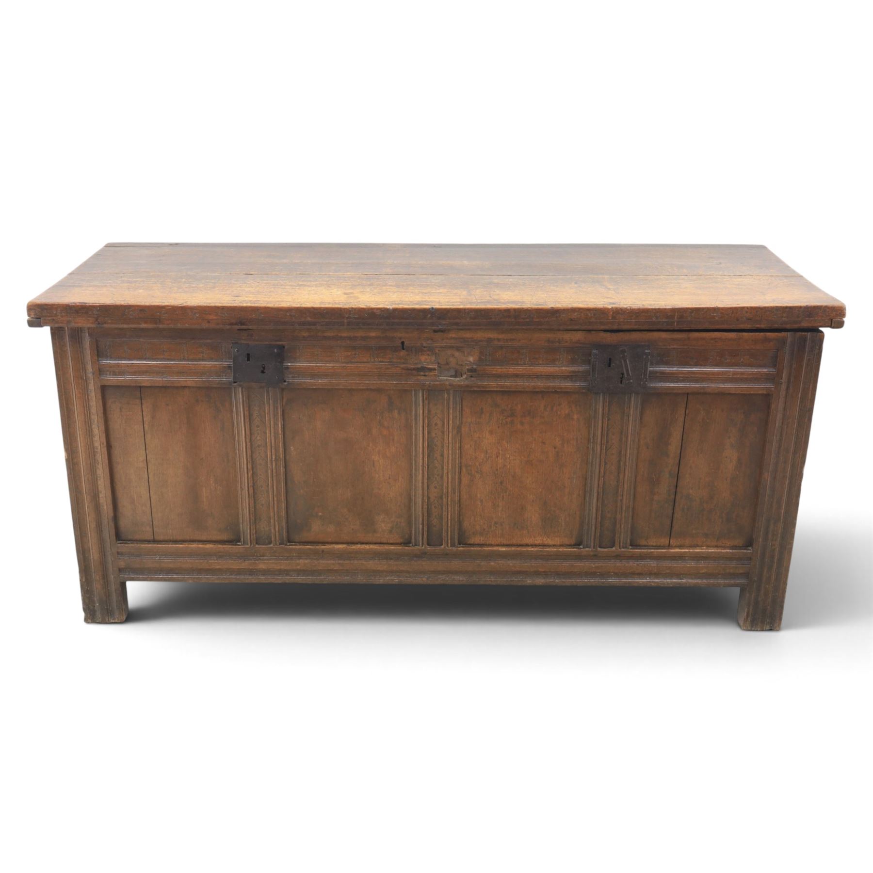 Large 17th century oak coffer, plank top with moulded edge, four panel front with channel moulded uprights, retaining original wrought iron strap hinges and central lock plate, panelled ends, raised on stile supports