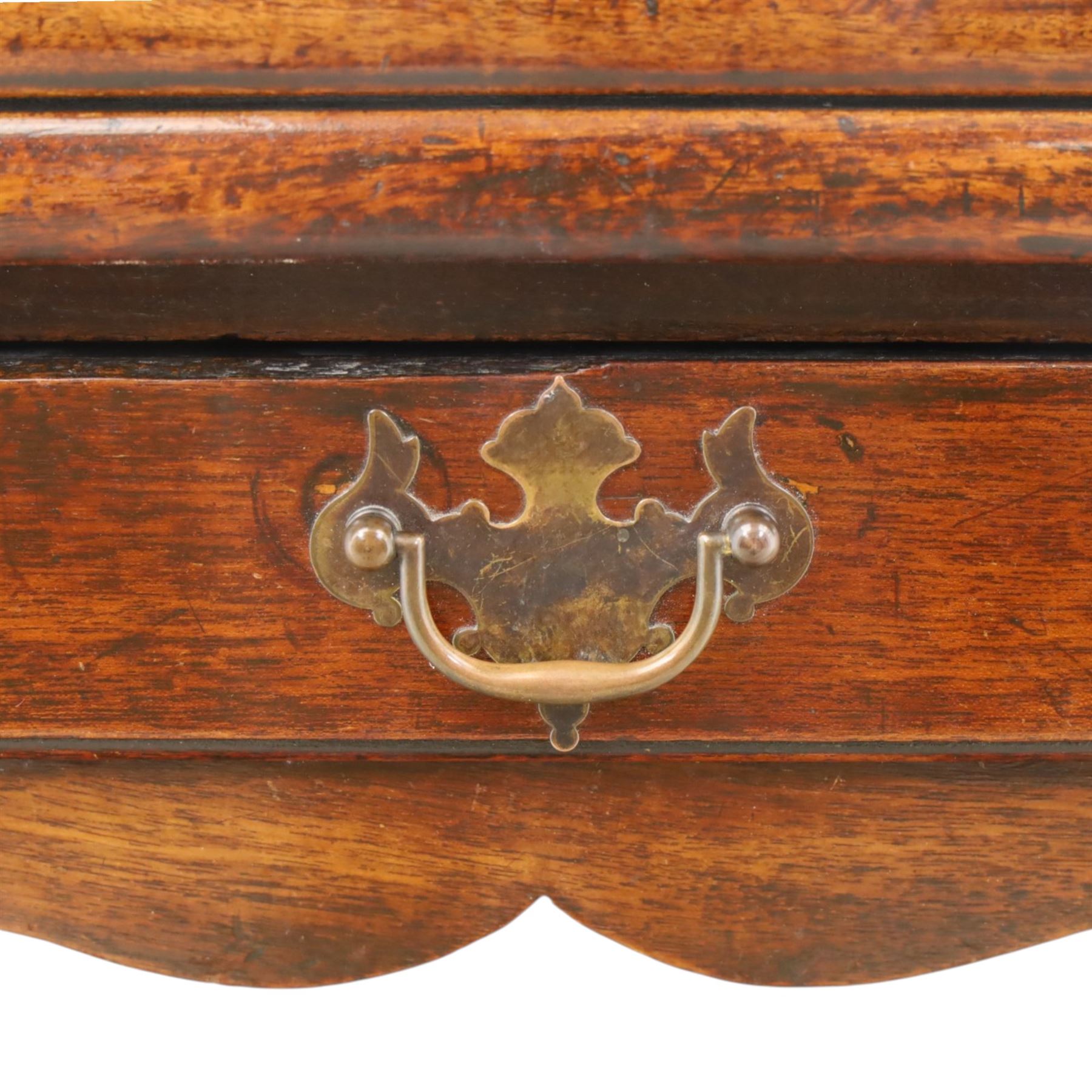 Georgian oak tea table, rectangular fold-over top above single frieze drawer with brass swing handle, shaped apron, gateleg raised on square tapering supports
