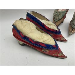 Two pairs of Chinese silk embroidered lotus shoes, for bound feet, one example with floral decoration upon a red ground with blue band, and a similar smaller pair, largest L15cm