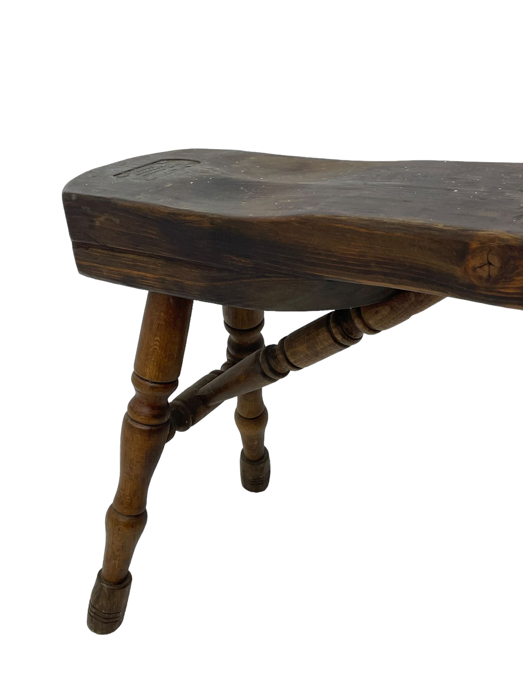 Early 19th century cobbler's work bench, in various woods, revolving cast iron last on yew wood supports, pine seat with inset maker's plaque inscribed 'No 7 Josh Blacker Harehills Leeds', on turned elm front supports and turned beech rear supports 