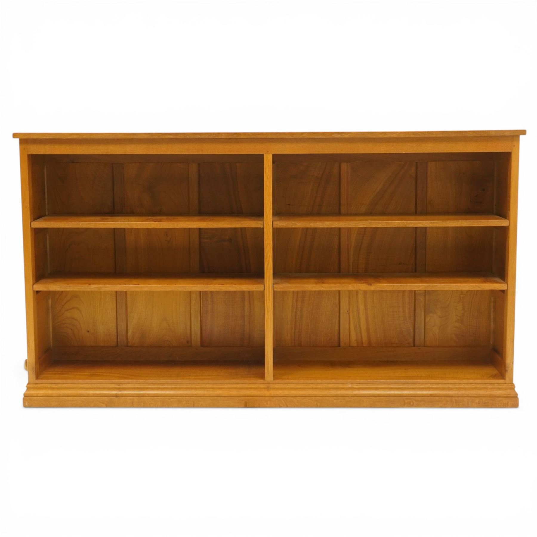 Beaverman -  Adzed oak open bookcase, with two sets of two adjustable shelves, panelled sides on a plinth base, with carved beaver signature, by Colin Almack of Sutton near Thirsk