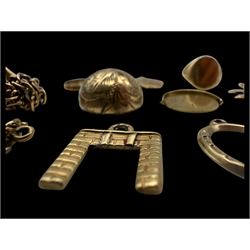 9ct gold charms, including crossed swords, signet ring, horseshoe and leaf, and a 14ct gold fireplace charm