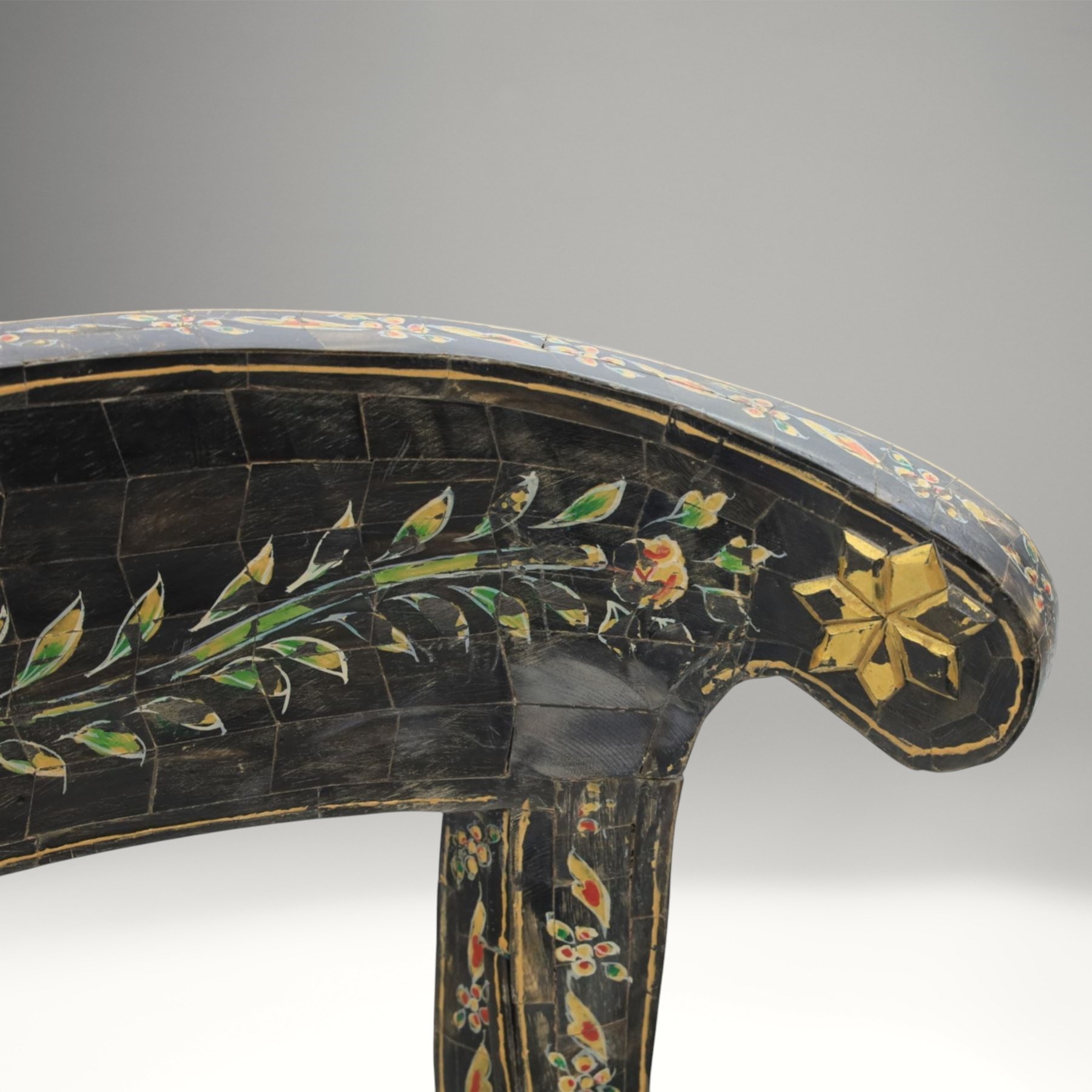 Early 20th century Anglo-Indian painted and inlaid armchairs, each with shaped top rail decorated with polychrome floral motifs above turned spindle galleries, shaped open arms and upholstered seats, on square supports with similar painted decoration
