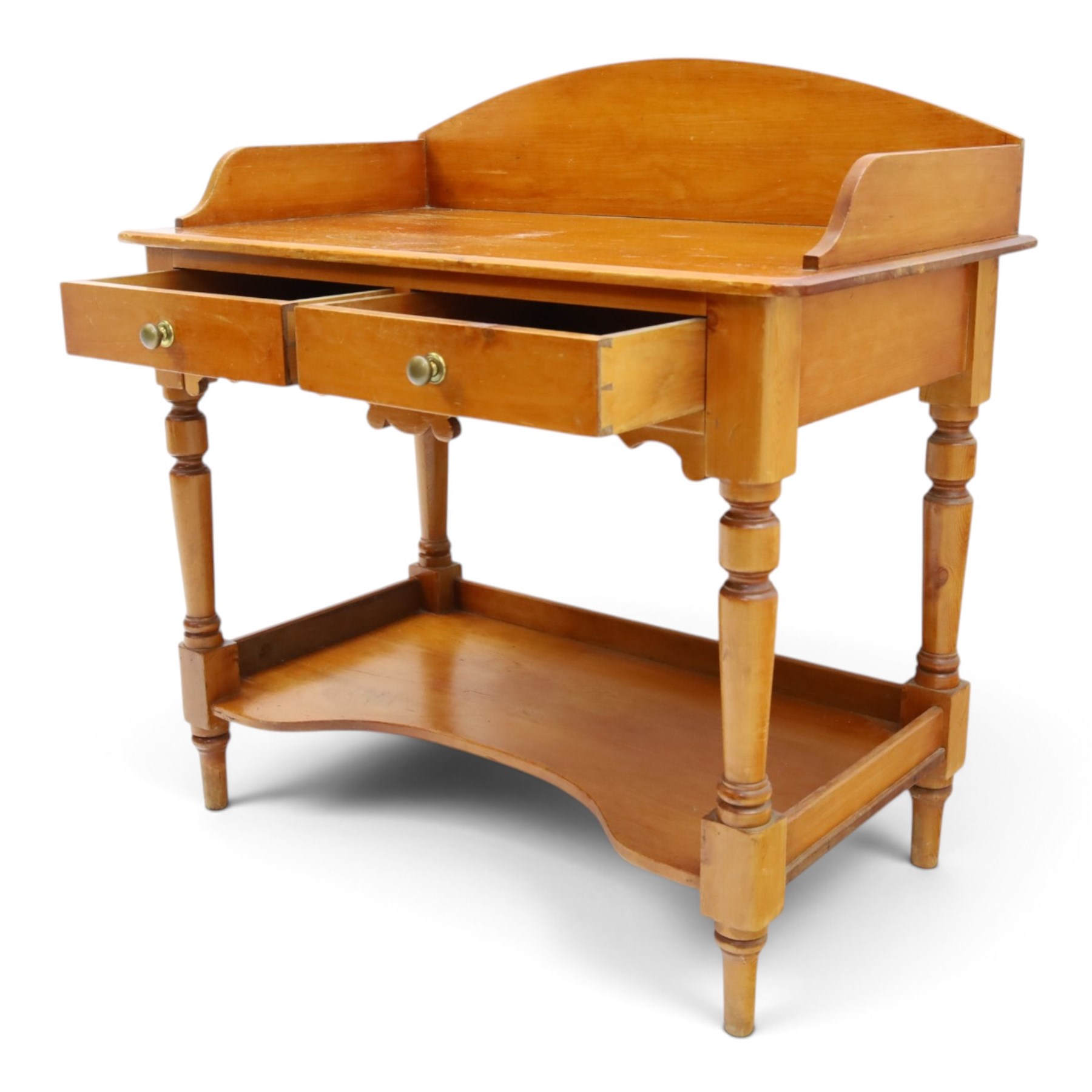 Victorian pine washstand, raised three quarter galleried top, fitted with two drawers, raised on turned supports united by a shaped full length under tier 