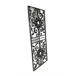 Wrought metal work panel, decorated with scrolls and foliage, central flower head motifs, black paint finish