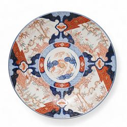Late 19th/early 20th century Japanese imari charger, decorated with panels of mountains and bamboo, D46cm, and a large imari pattern stick stand, H48cm (2)