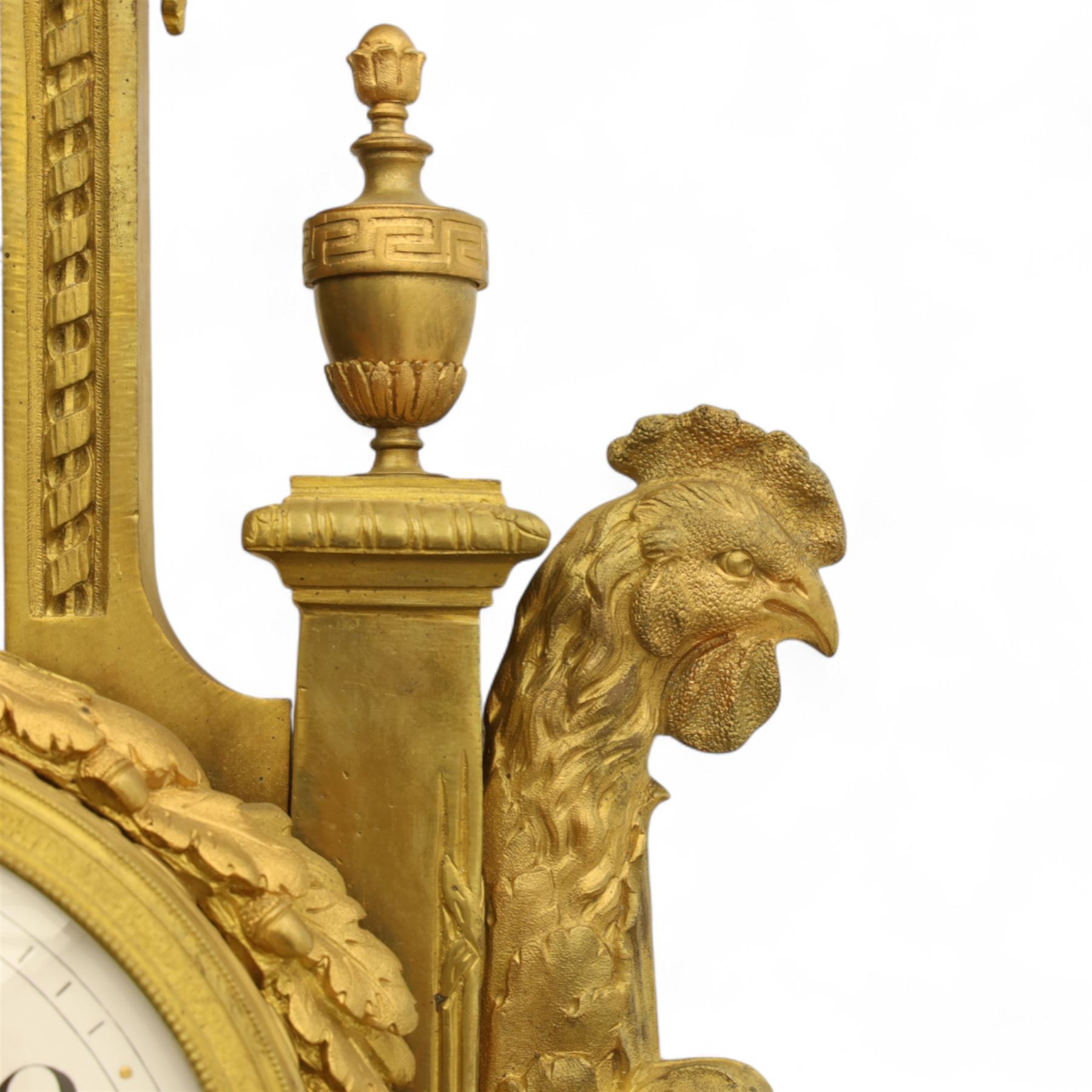 French- late 19th century cast brass and ormolu 8-day cartel wall clock, with a profusely decorated case comprising urn finials garland wreaths, ribbon bows and French cockerels, white enamel dial with minute track, Arabic numerals, garland swags and pierced gilt hands, twin train movement with a recoil anchor escapement and countwheel strike, striking the hours and half-hours on a bell. With pendulum and key.