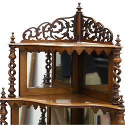 Victorian mahogany five-tier corner whatnot, raised and pierced back of scrolling foliate design, over two tiers with mirror backs and pear-drop moulded aprons, united by pierced spiral-turned uprights, on turned feet