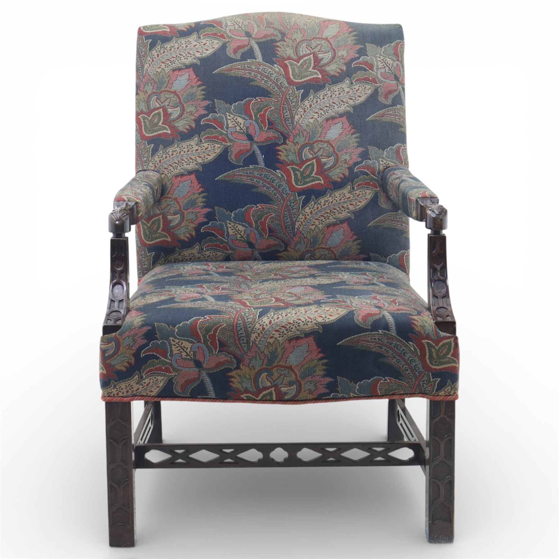 Early 20th century Chippendale revival Gainsborough elbow chair, rectangular upholstered back and seat covered in foliate patterned fabric, with open arms carved to the terminals and supports with pierced and geometric detail, raised on square section legs with blind fretwork panels