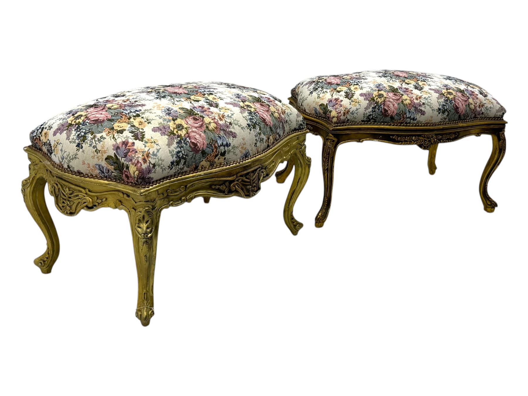 Pair of Louis XV-design giltwood stools, each upholstered in floral tapestry fabric, the carved frame adorned with scrolling foliage and shell motifs, raised on cabriole supports