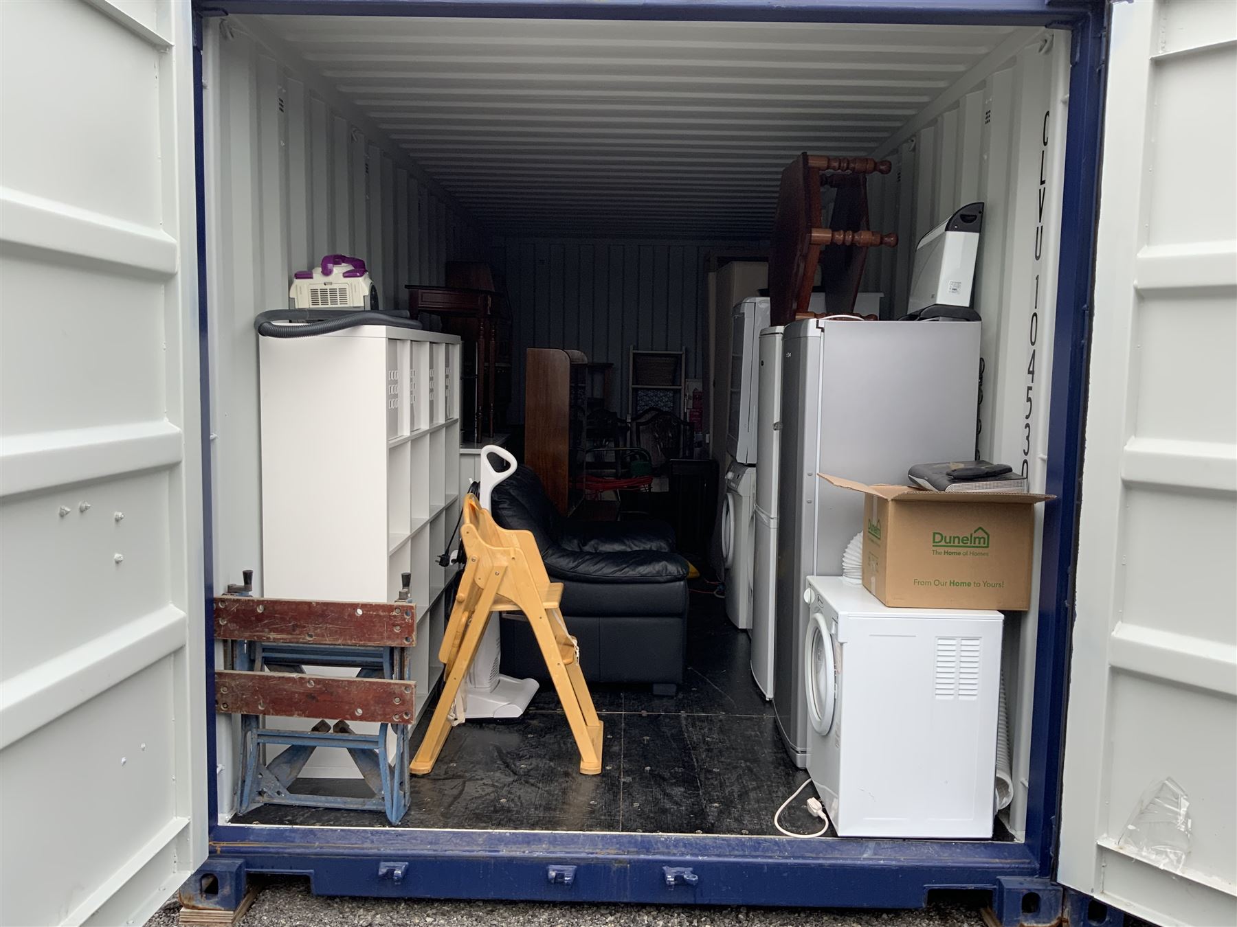 Container Contents Auction entire container contents to include white goods, sideboard, tv