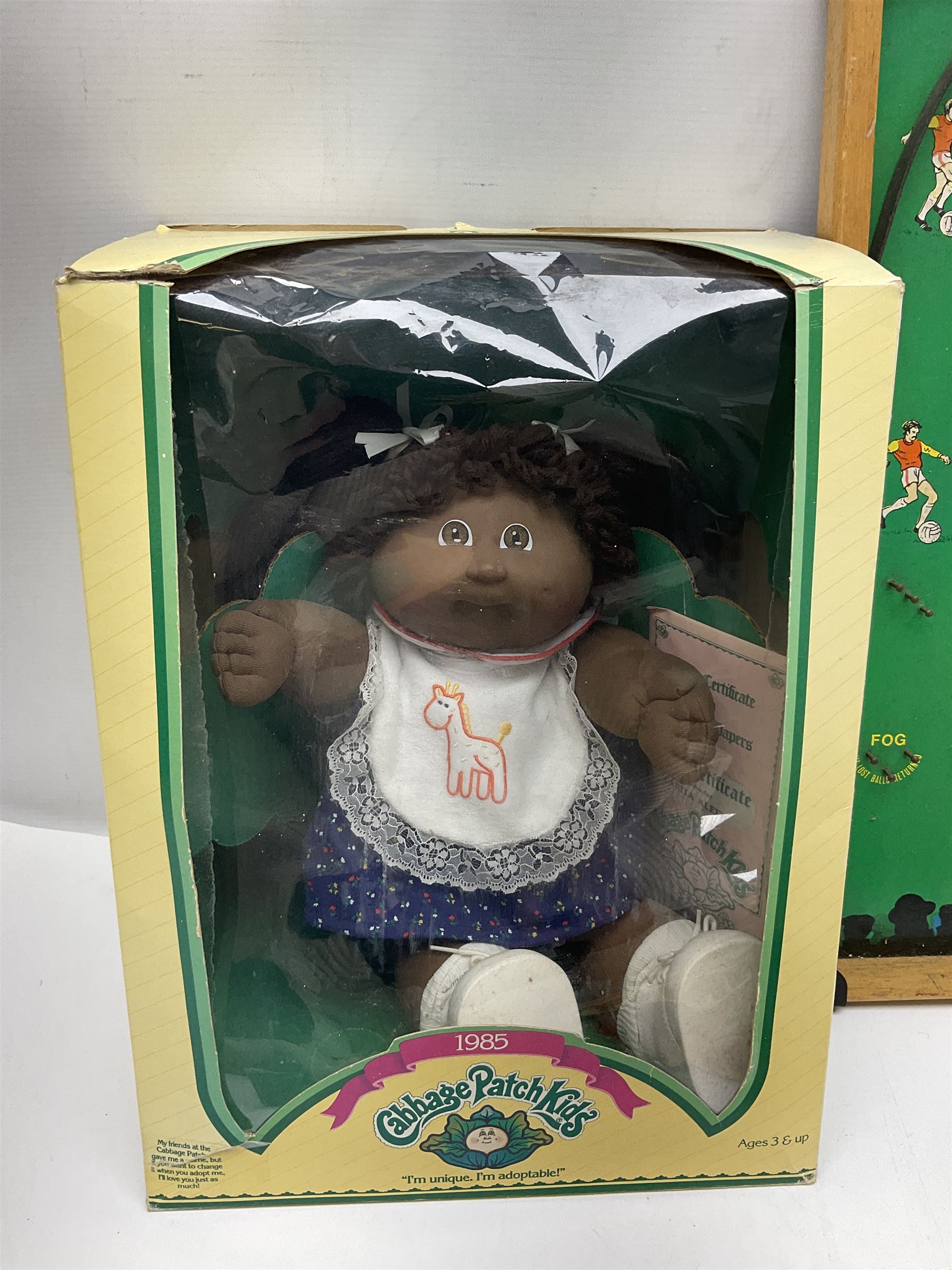 Ideal 'Tank Command' battle action game; boxed; Kay 'Pin Football' bagatelle game; Coleco Cabbage Patch Kids 'Carita Aleen' doll; boxed with certificate; and Palitoy composition head and body doll; boxed (4)