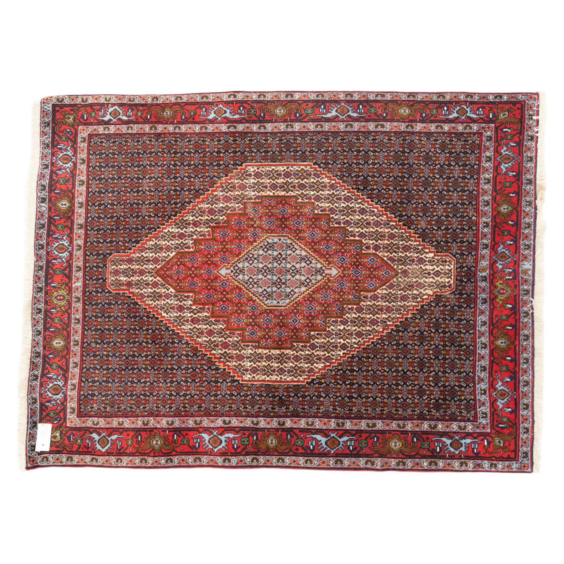 Persian Ardakan rug, featuring central elongated diamond medallion with serrated edges on a repeat boteh field, framed by triple guard borders with red floral scroll design