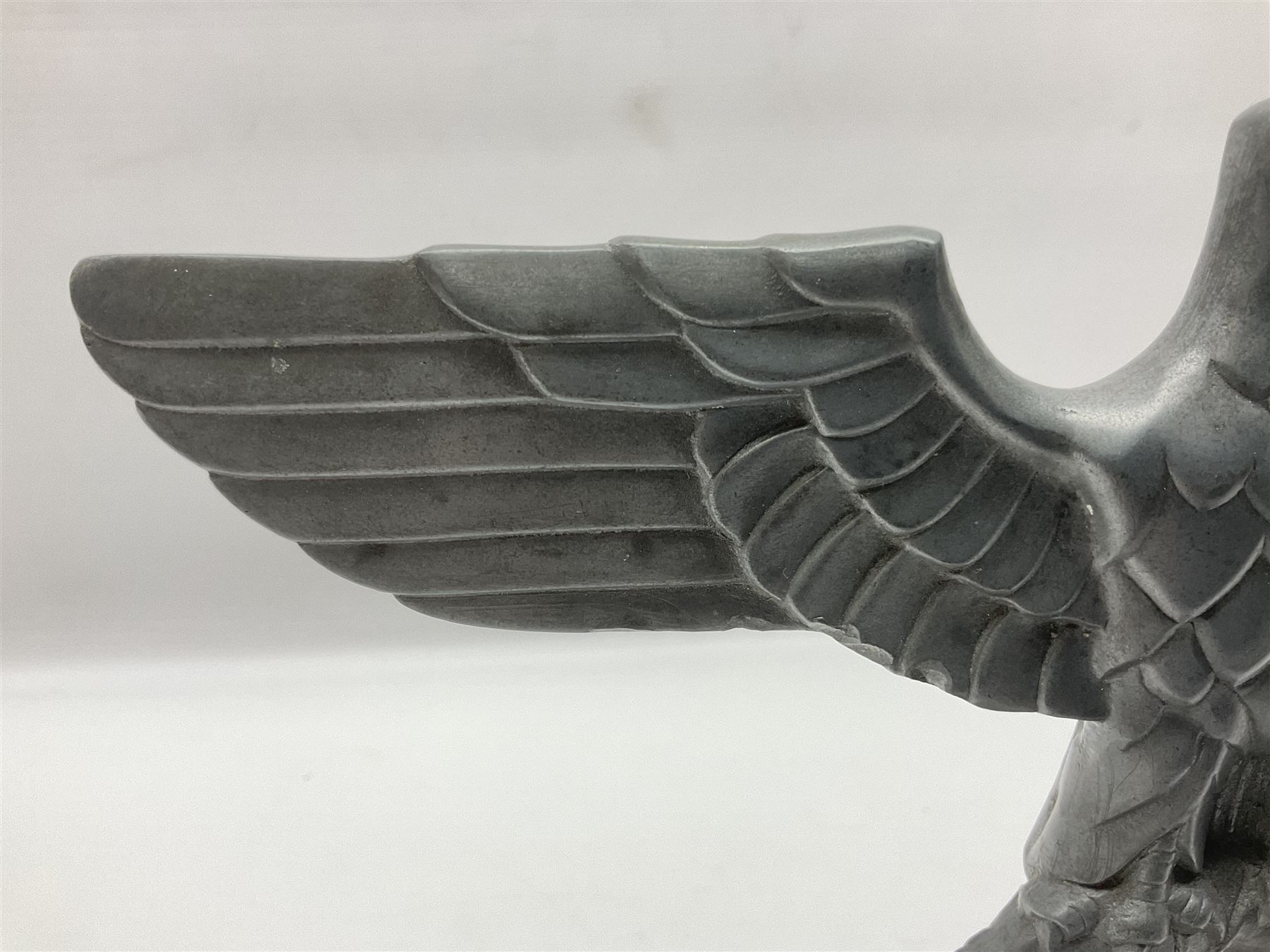 WW2 German cast white metal desk ornament/paperweight as the eagle insignia on later turned mahogany plinth H22cm