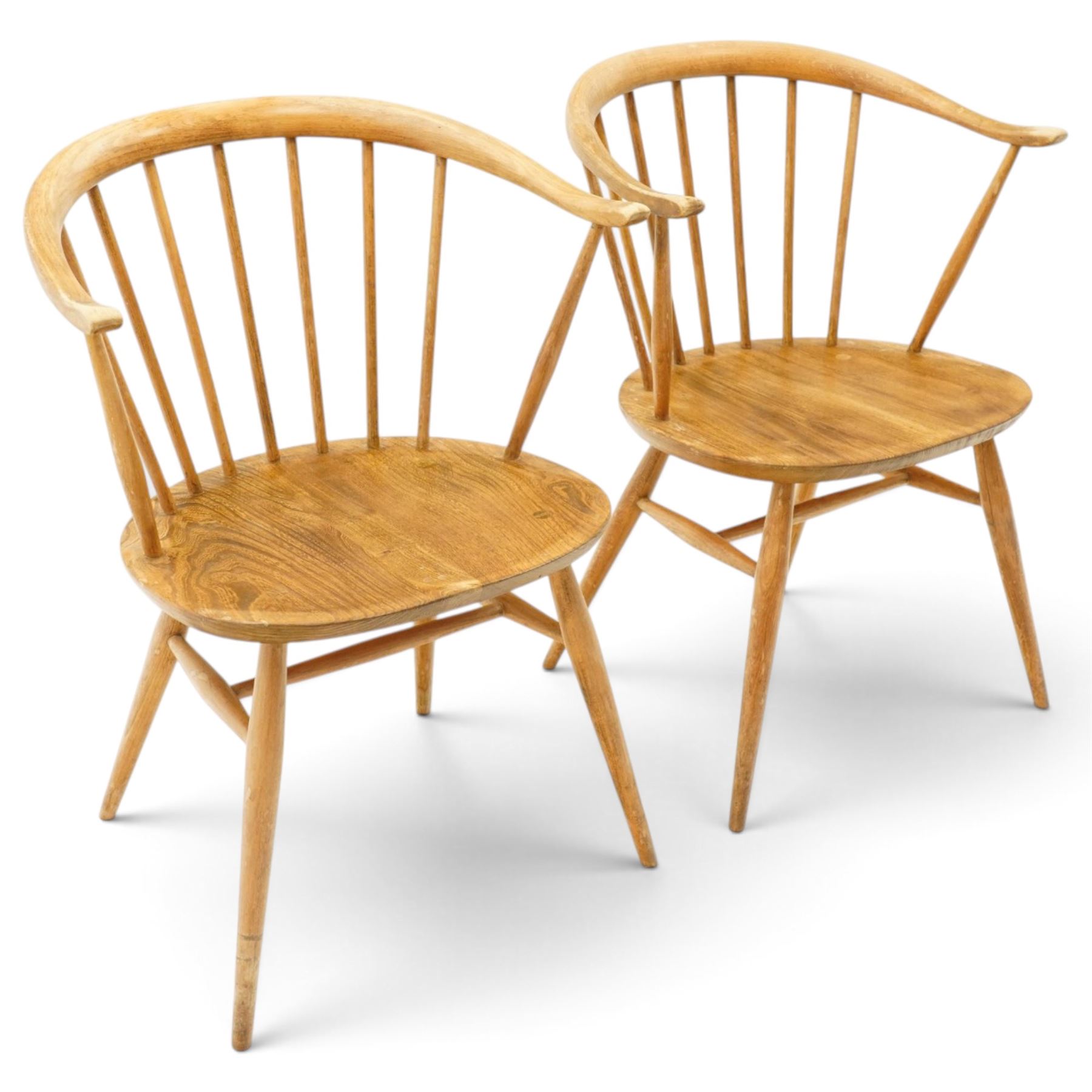 Ercol - pair of 'Cowhorn' elm carver chairs, curved back raised on nine stretchers, elm dished seats, raised on tapering supports