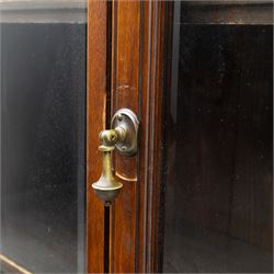 Late 19th century walnut library bookcase, fitted with four display doors with astragal bevelled panes, raised upon a four cupboard base with fielded panel doors
