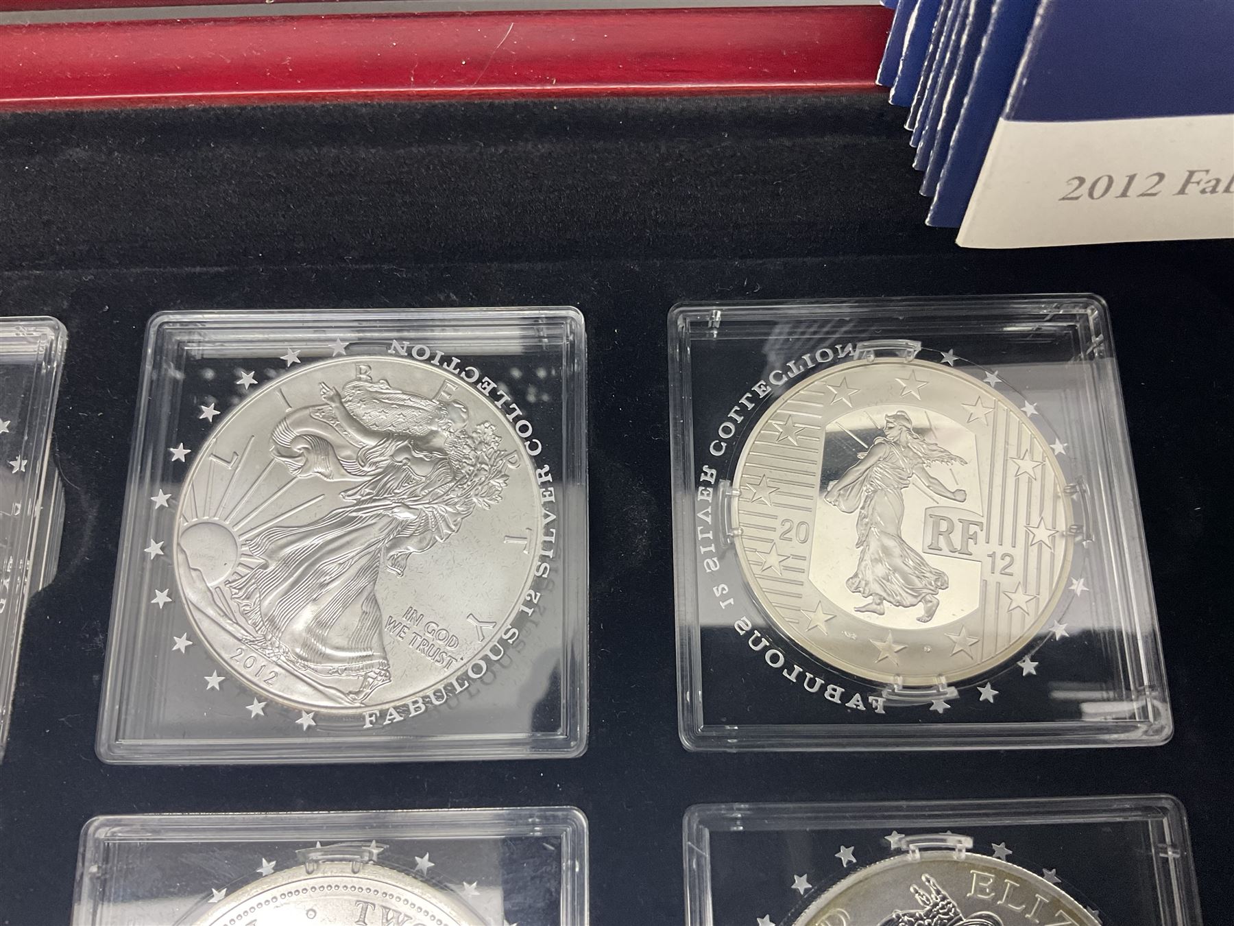 'The 2012 Fabulous 12 Silver Coin Collection' including Queen Elizabeth II Britannia one ounce silver two pound coin, Queen Elizabeth II Canada Maple Leaf one ounce silver five dollar coin, Queen Elizabeth II Australian Koala one ounce silver one dollar coin, Austrian Philharmonic one and a half euro coin, etc., in wooden presentation case