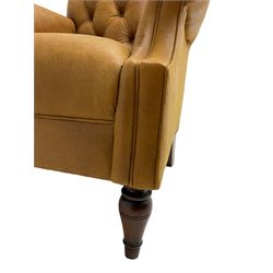 Georgian design armchair, upholstered in buttoned tan leather with over-stuffed seat and scrolled arms, raised on turned tapering front feet