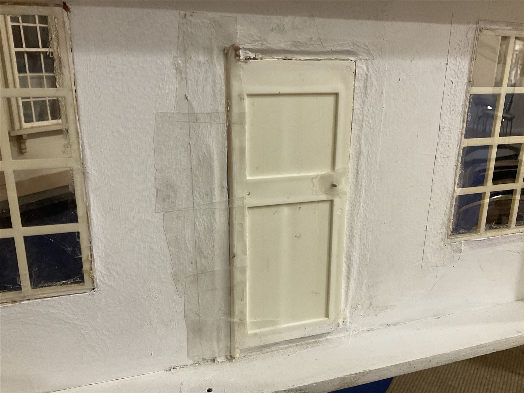 Modern scratch-built Palladian style wooden dolls  house as a 19th century double fronted two-storey property with simulated brick and stone walls under a removable simulated slate hipped roof; the triple hinged front elevation opening to reveal six rooms with central hall, stairs and landing L94cm H56cm D40cm