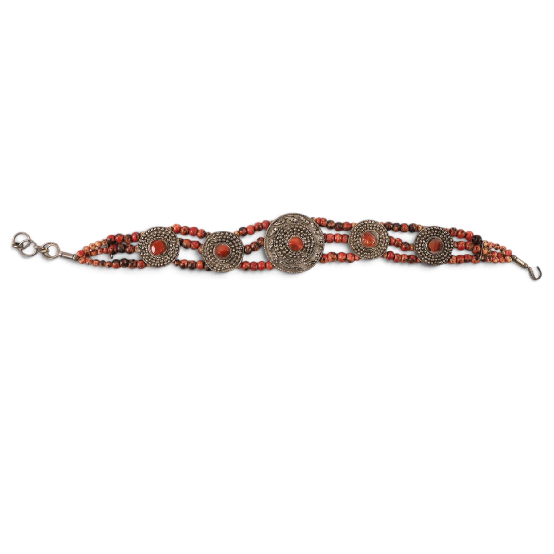 Collection of Middle Eastern jewellery, including silvered multi strand necklace with beadwork and filigree decoration with three cylindrical pendants, pendant necklace with central orange cabochon, beadwork choker and similar  