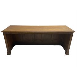 Illingworth Ingham and Co. School Furnishers (Leeds c1900) - early 20th century oak rostrum or headmaster's desk, rectangular top, the front and sides panelled with open reverse, on plinth base